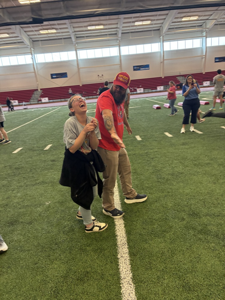 student laughing with teacher