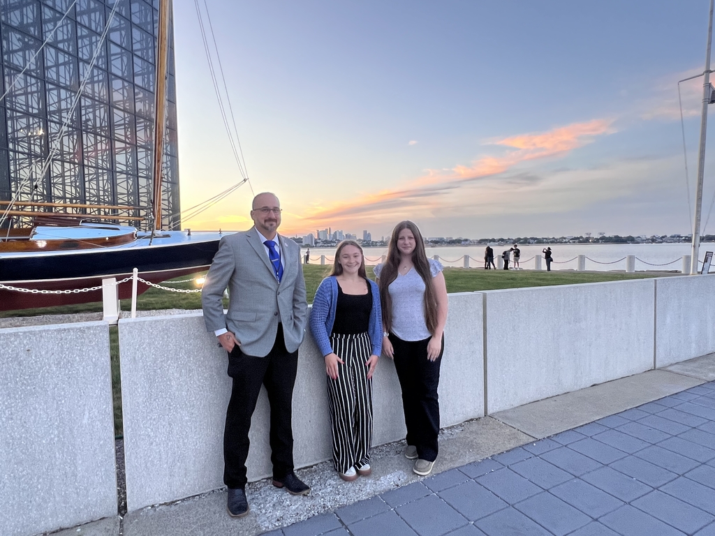 Superintendent Blake Vargas and students Kinlee Littleford and Samantha Roberts Dildine visited the John F. Kennedy Presidential Library and Museum as one the outings in the immersive experience in Boston. Behind them is The Victura Sailboat, President Kennedy's beloved 26-foot wooden sailboat, which is prominently displayed outside on the museum lawn from May through November each year