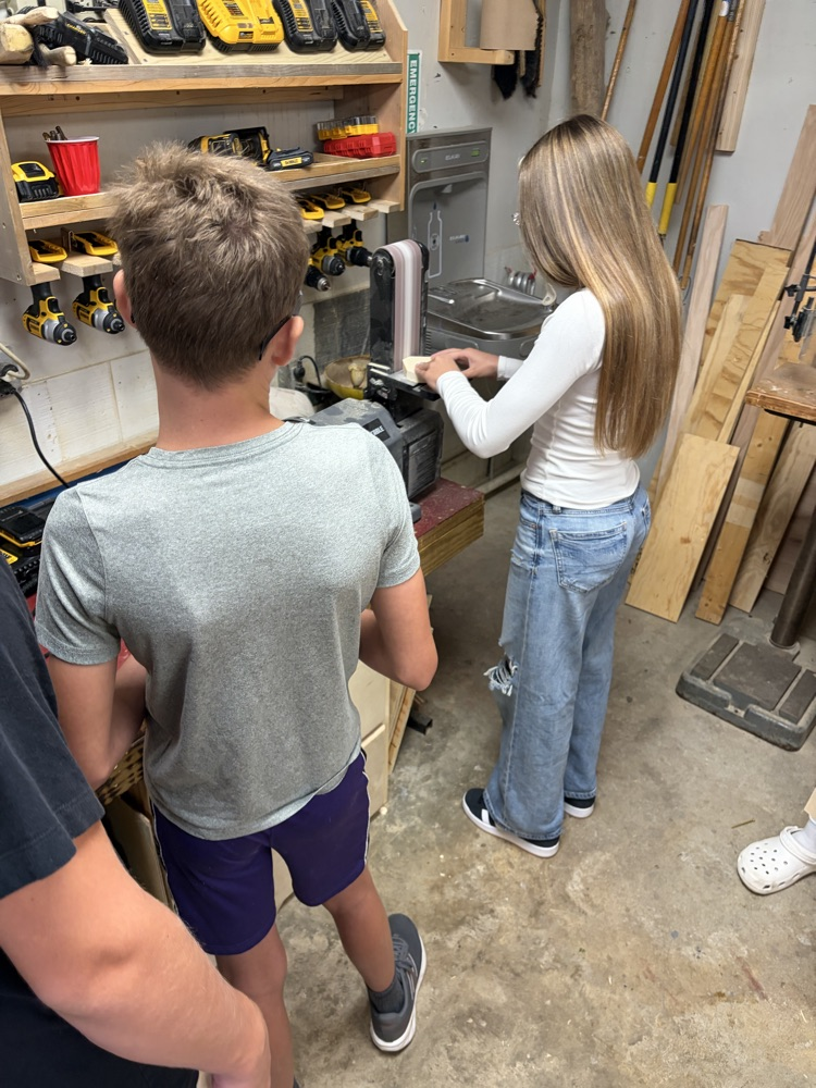 students sanding wood