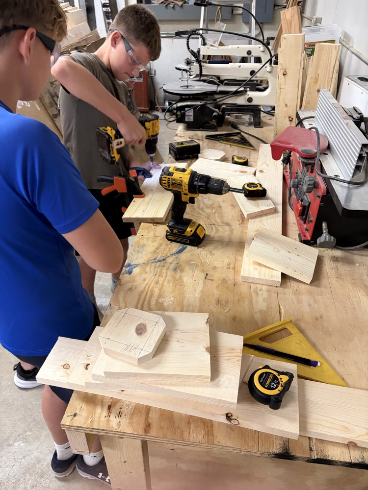 students drilling holes