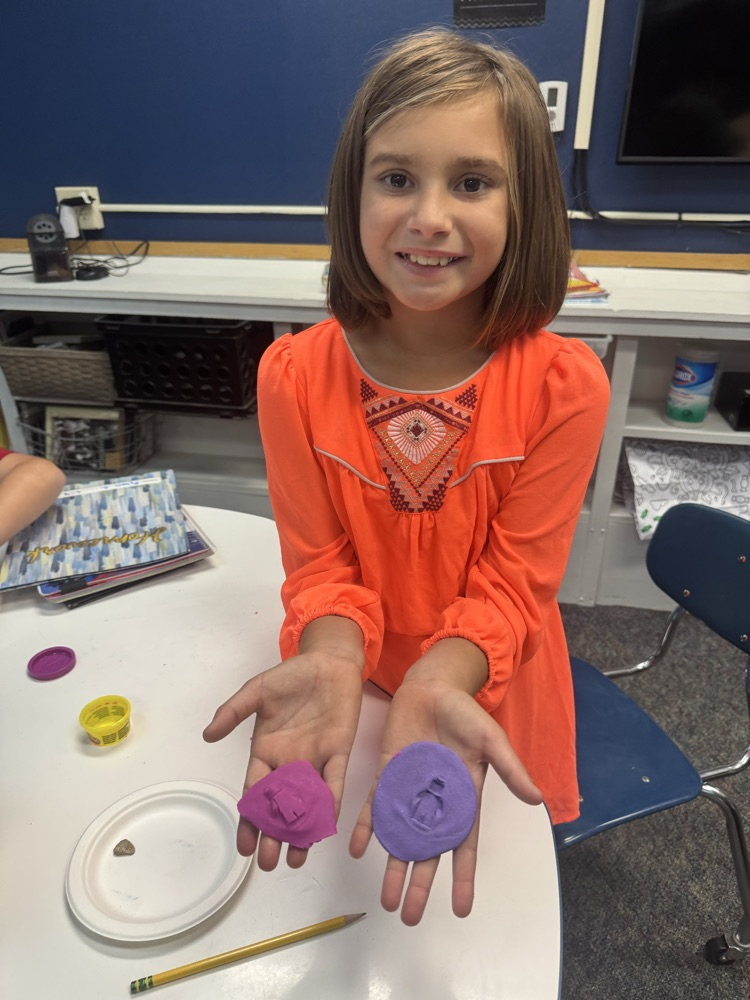 girl showing fossil