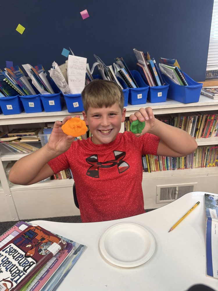 boy showing fossil