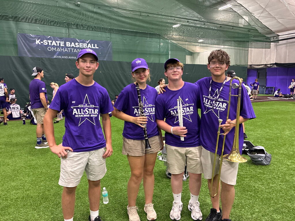 Studetns pose in the athletic facility prior to performing at the KState halftime performance.