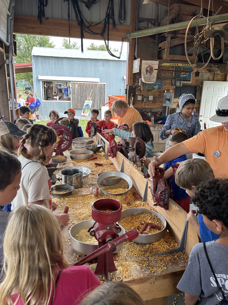 students grinding corn