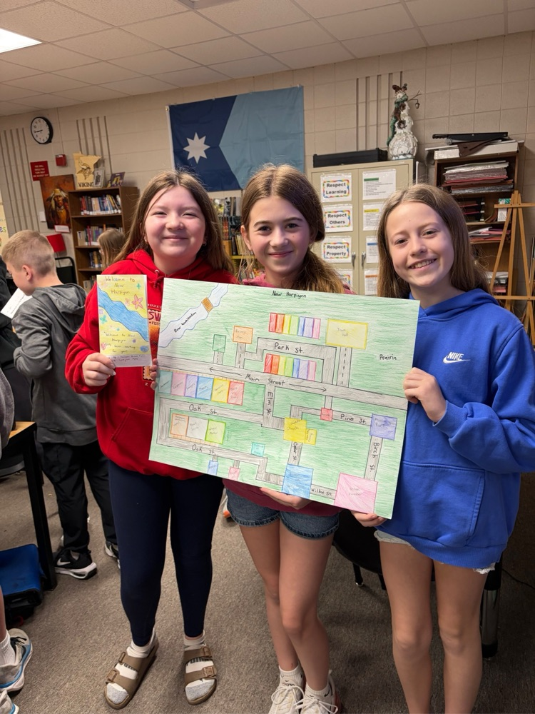 students holding their town poster board project