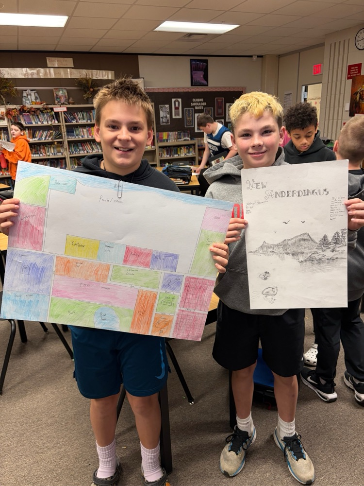 students holding their town poster board project