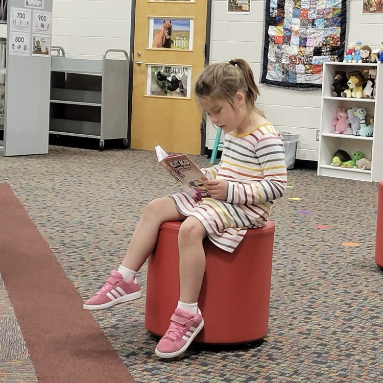 students reading in the library
