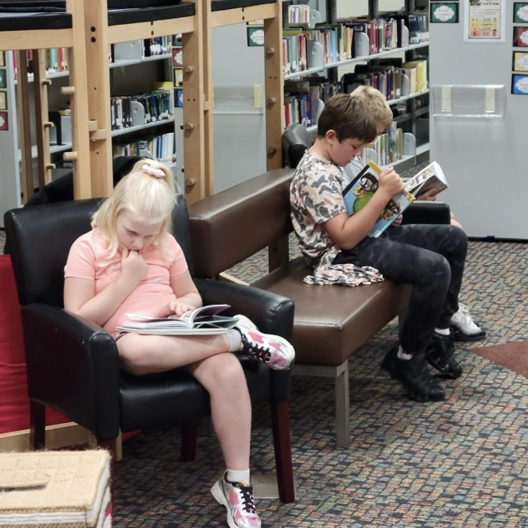 students reading in the library