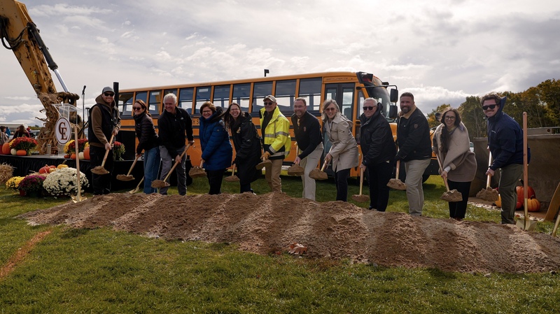 building project team members breaking ground