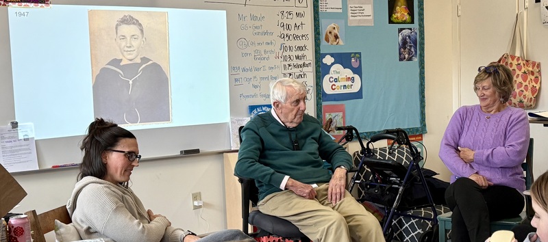 war veteran presenting in class with wife and daughter by his side