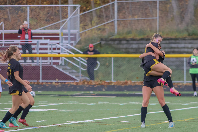 cape elizabeth girls soccer players celebrating win with a hug