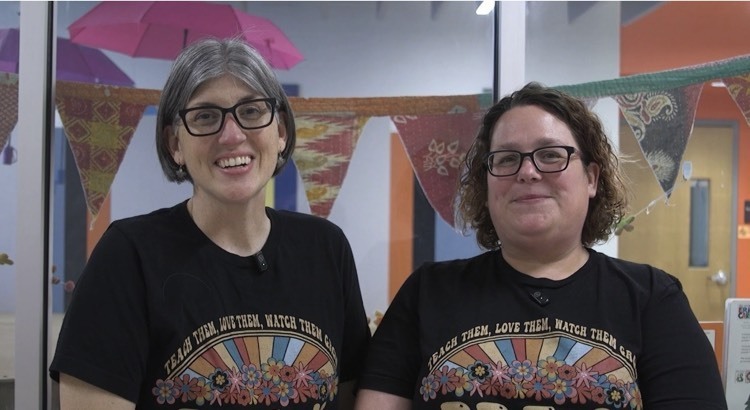 two teachers pose for the camera