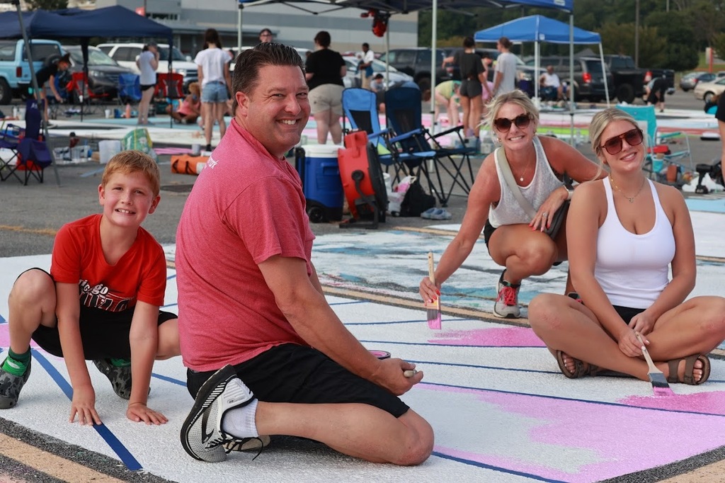 Student's family helps with painting