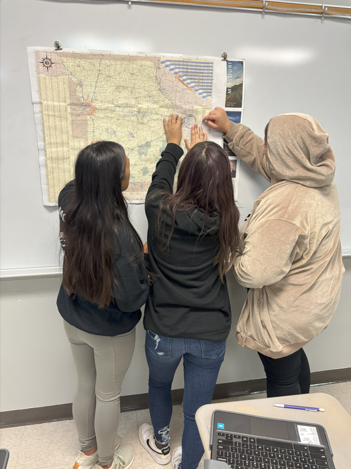 Girls study Missouri map