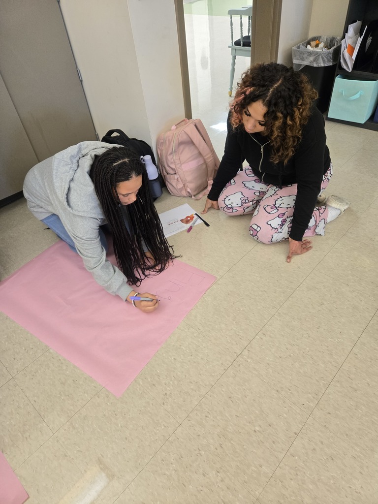 Members work on their advertisement 