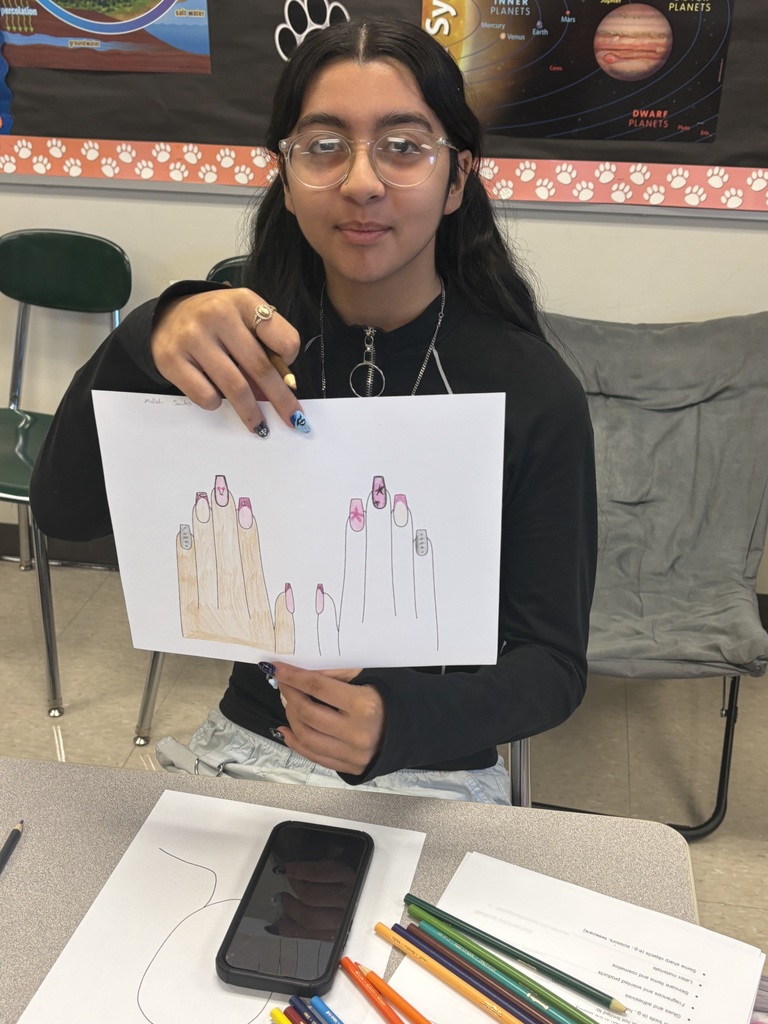 Student shows off her nail designs.