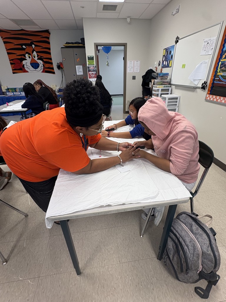 Ms. Mills assists a student.