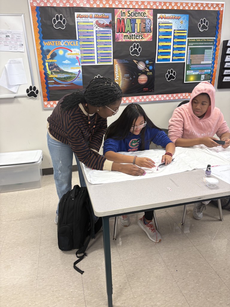 Ms. Hall assists a student.
