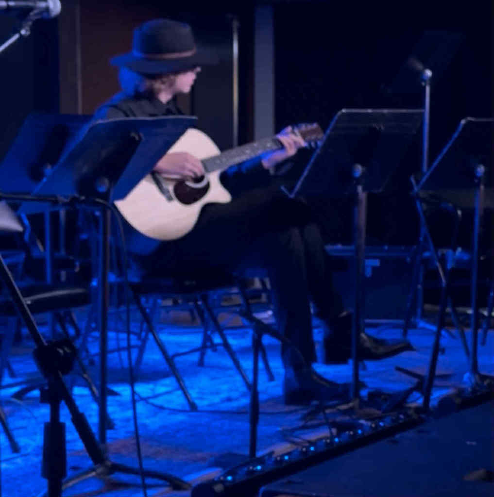 A student plays guitar