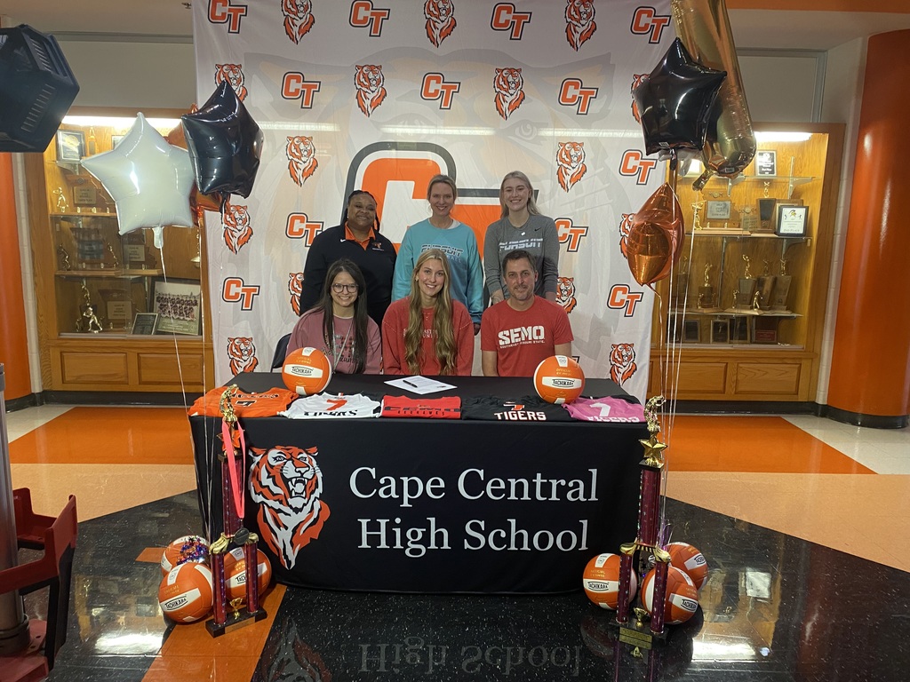 Sydney Miller poses with her family and coaches for a picture