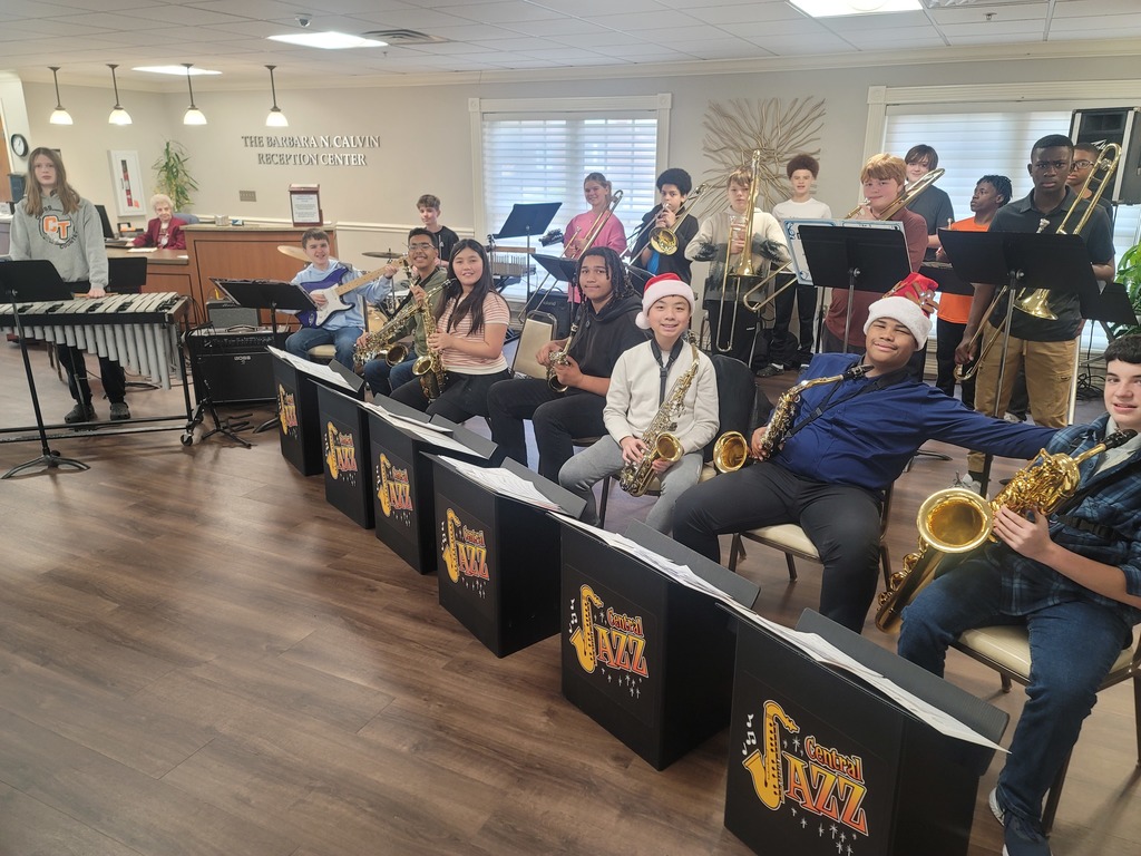 Students pose for a picture with instruments