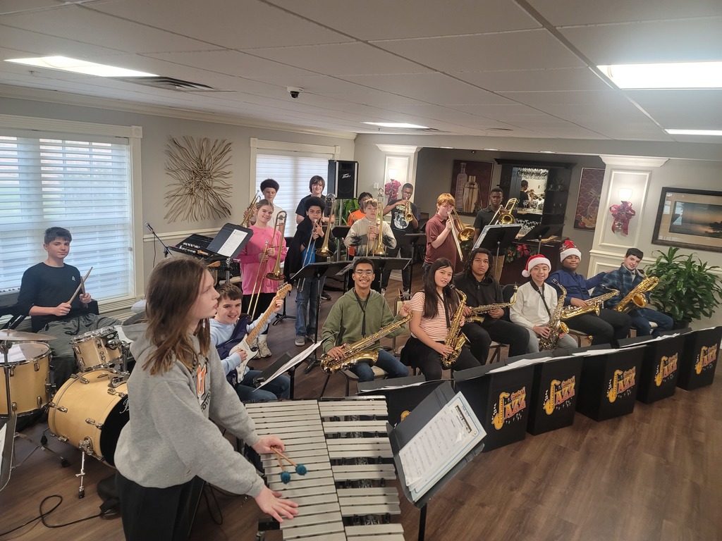 Students pose with their jazz instruments before they perform