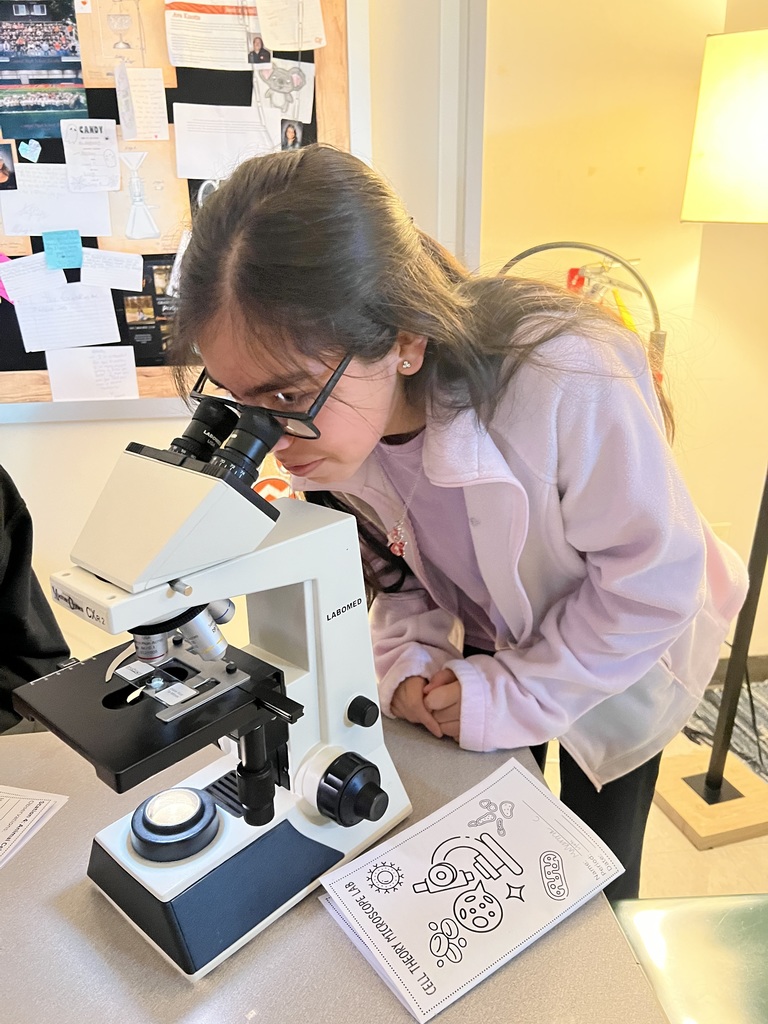 student uses microscope