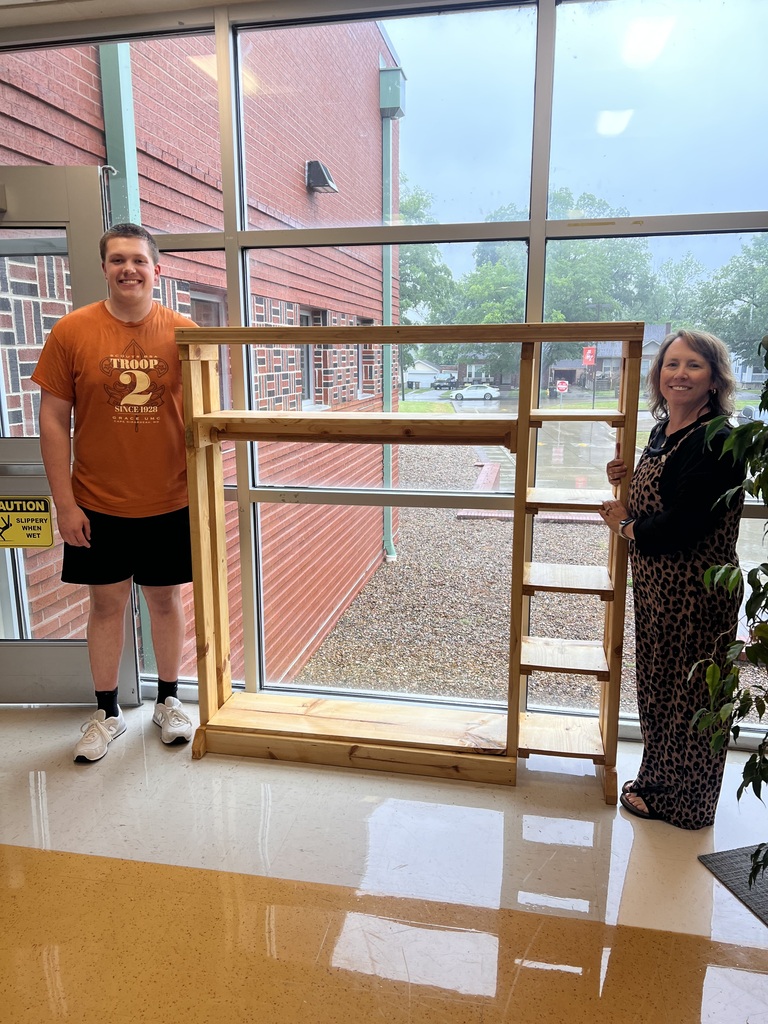 Warner Durham poses with Principal Roanne Dean by the lost and found cubby Warner built