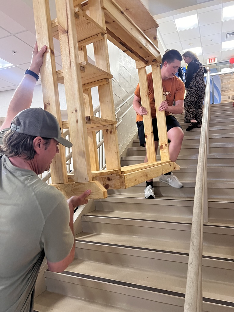 Warner Durham moves the lost and found cubby up the steps at Franklin Elementary with support from another volunteer