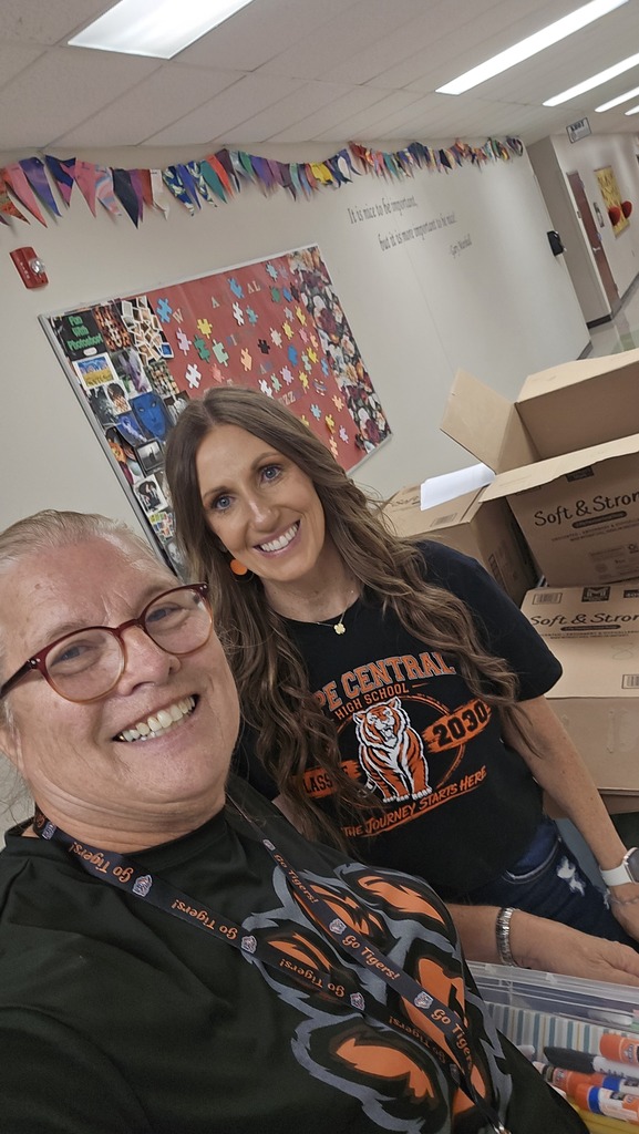 Office assistants giving gift to teacher