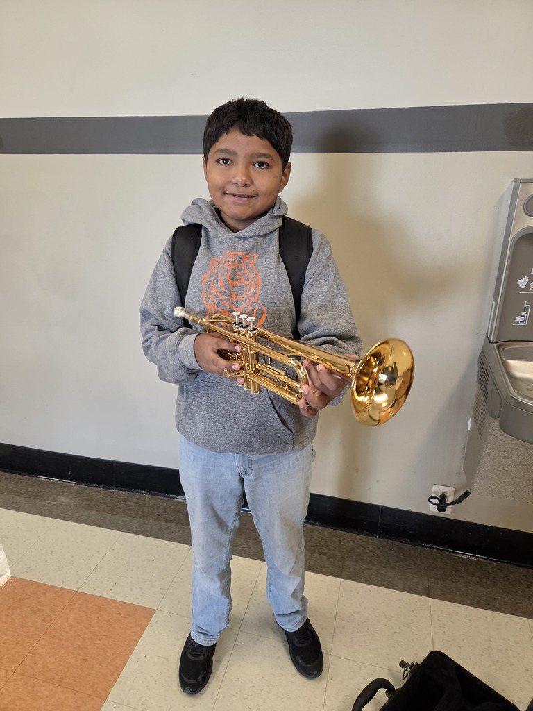 A Cape Public Schools student smiling while holding their new trumpet.