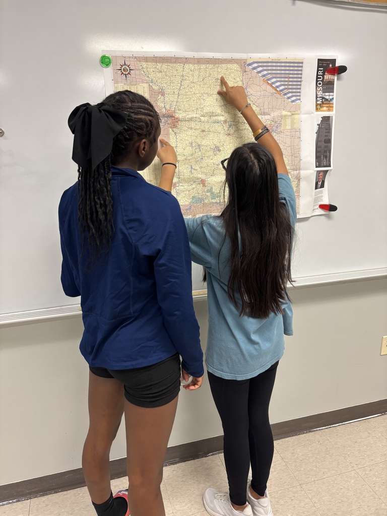 Two students study a map