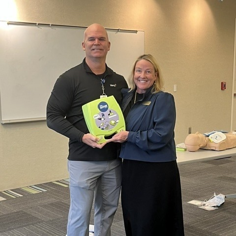 Scott Givens, director, receives an Automated External Defibrillator (AED) funded through a grant from Mercy Health Foundation Southeast. The AED will help improve emergency preparedness and safety for Cape Girardeau Public Schools students, staff and visitors.