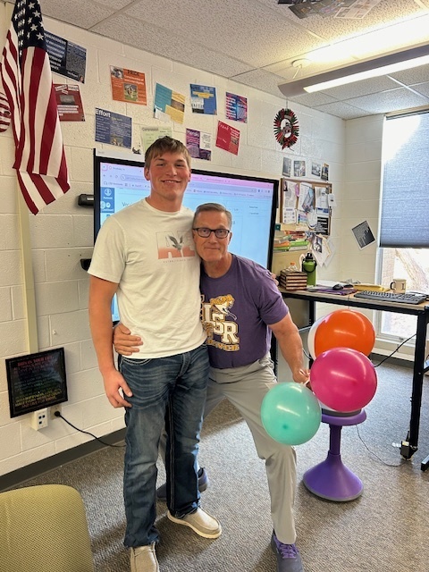 Student and teacher with balloons