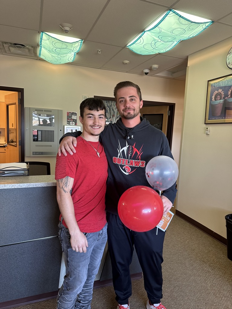 teacher with student balloons recognition