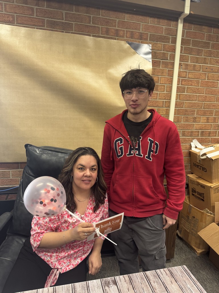 teacher with student balloons recognition