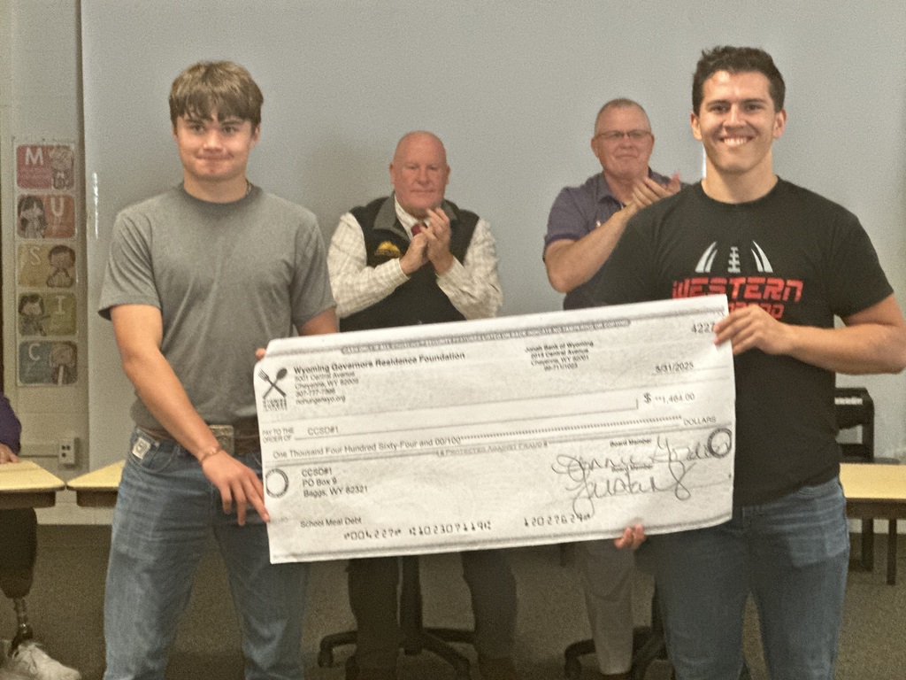 students presenting a check