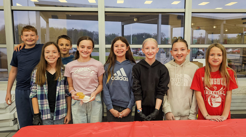 Cardinal Elementary School student council helps pass out doughnuts and sweep the floor at Doughnuts with Grownups.