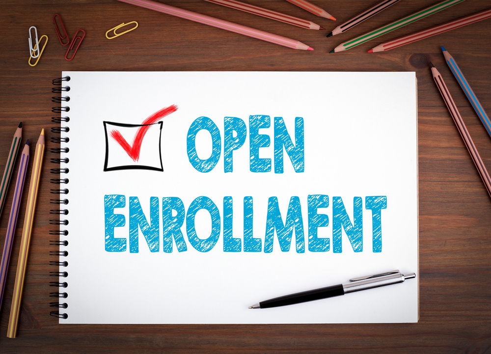 The words open enrollment on notebook paper