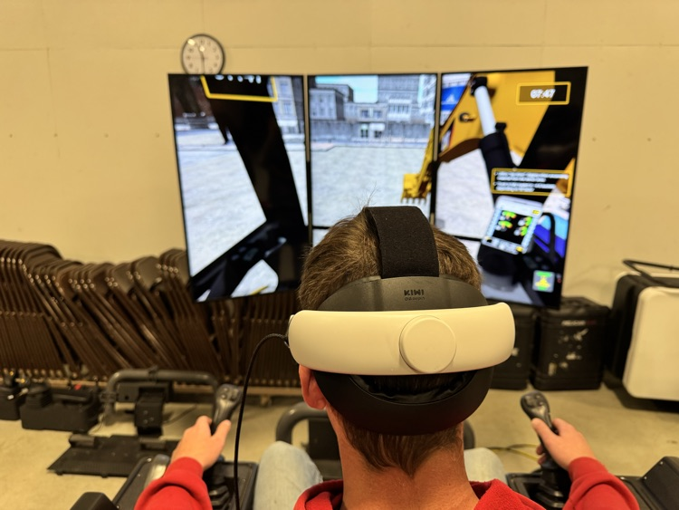 student using the mega simulator with a VR headset on