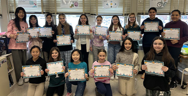 Students holding certificates