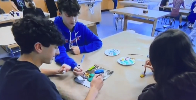 Students painting their projects.