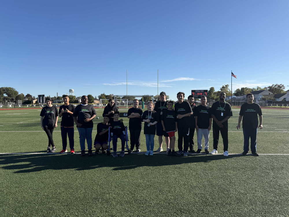 Students standing on field.