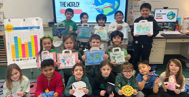 Students holding their artwork.