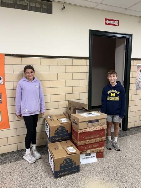 Students standing with boxes.