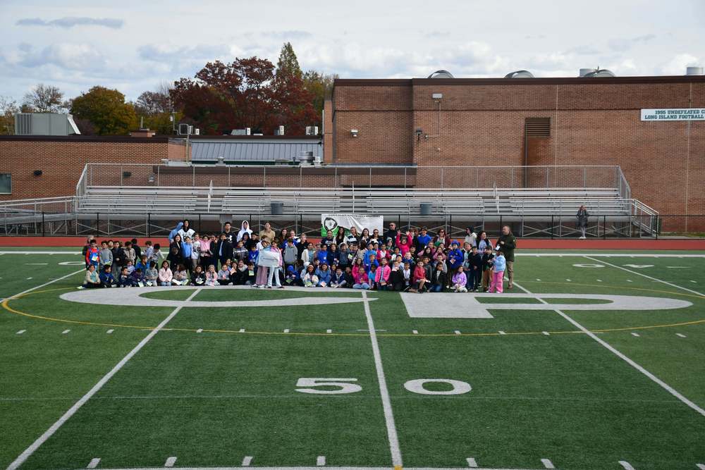 large group of people on football field