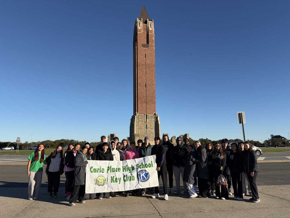Students standing in front of tower.