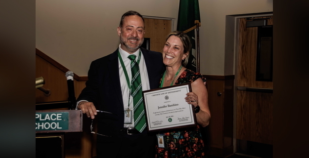 person with certificate at presentation ceremony at school