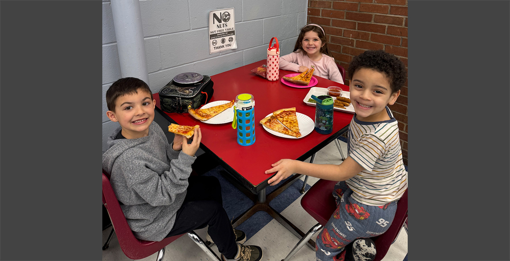 students eating pizza at a restaurant