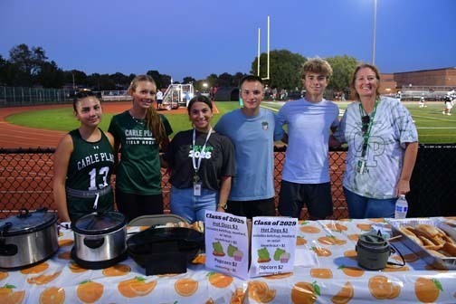 Football players and cheerleaders fundraising.